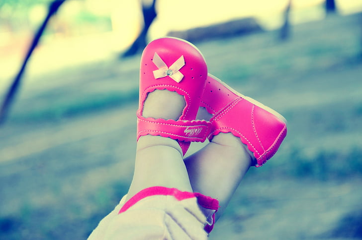toddler wearing pair of pink leather shoes