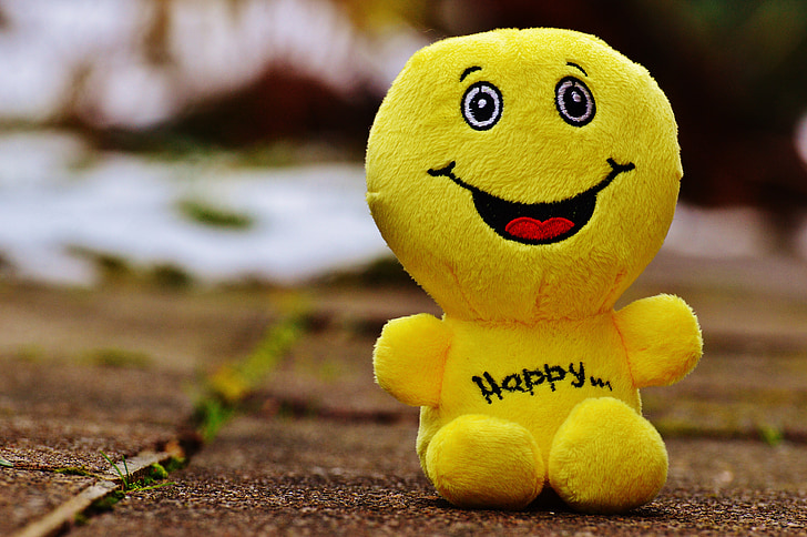 macro photo of yellow emoji plush toy