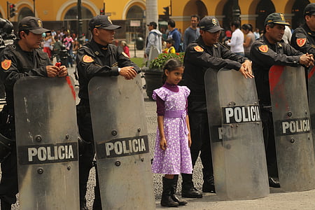 girl standing in the middle of policemen