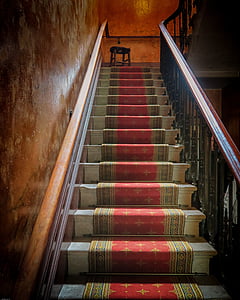 red and brown floor runner on stairway