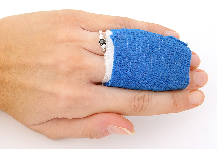 human hand with blue bandage