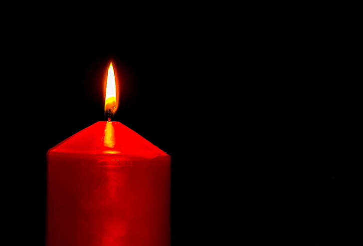 lighted red pillar candle