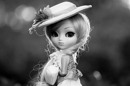grayscale photo of girl doll