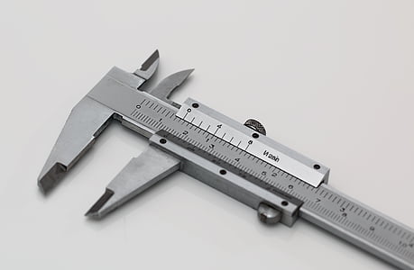 silver caliper on white surface