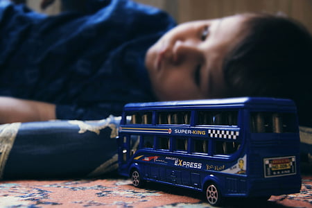 blue bus die-cast toy and boy force focus photography