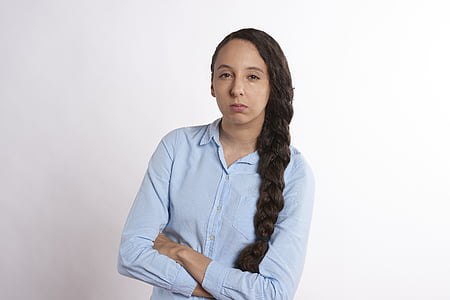 woman wearing blue dress shirt against white background