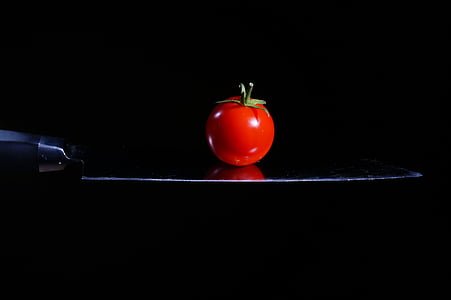 red tomato on black surface