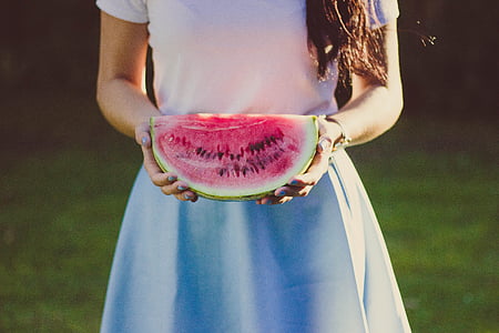 female holding water melon