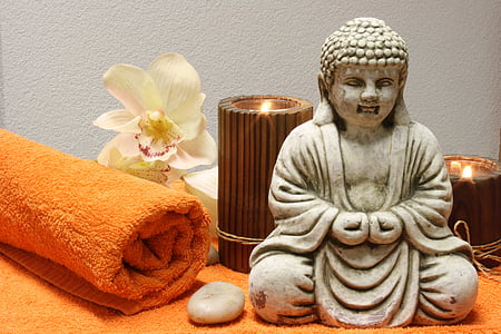 Buddha figurine near candle holders