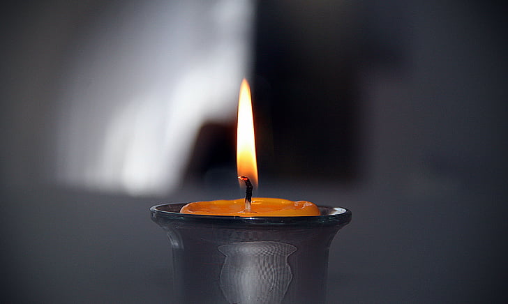 lighted candle in close up photography