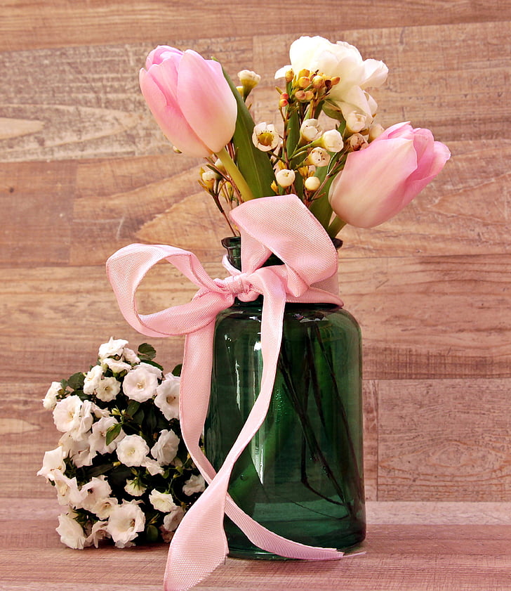 two pink and one white flowers on green vase