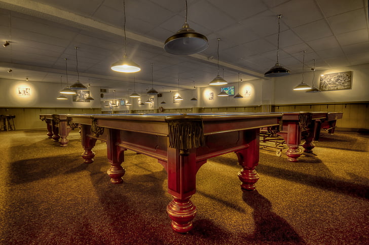 brown wooden pool tables inside room
