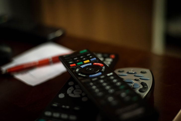 shallow focus photography of black remote controls