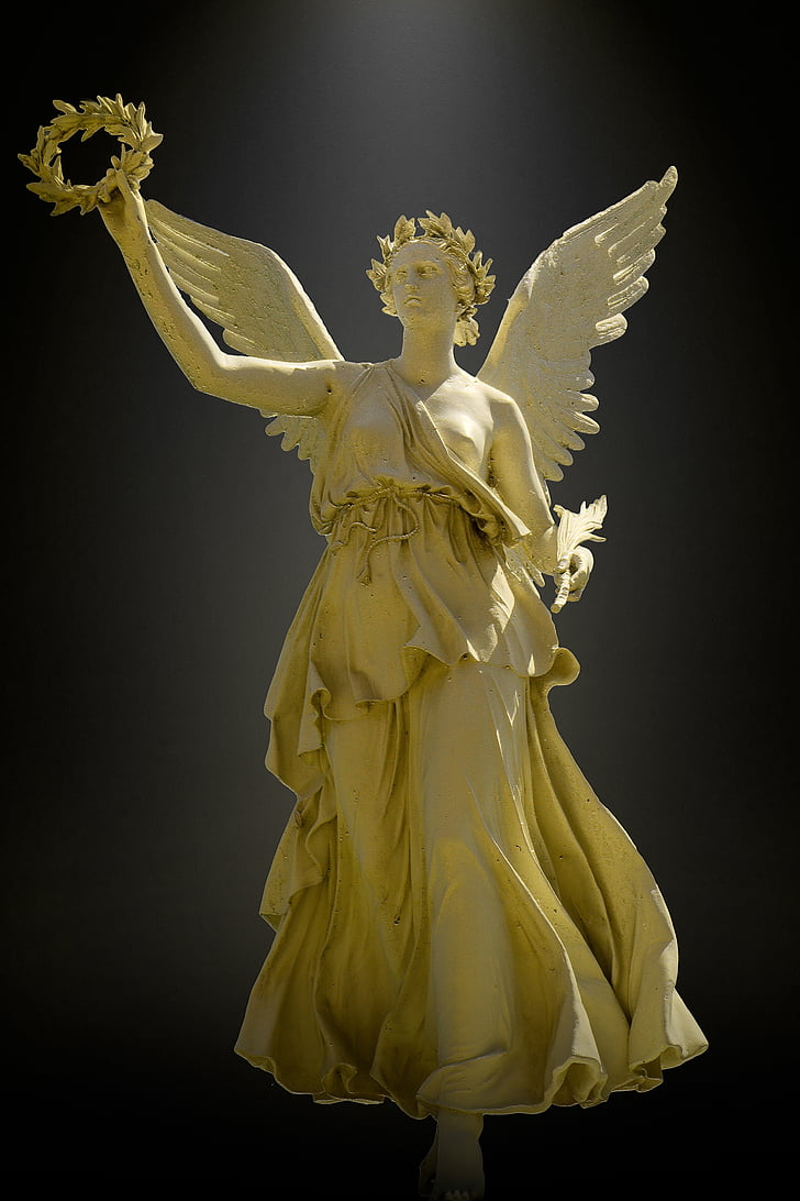 angel wearing one-shoulder dress statue