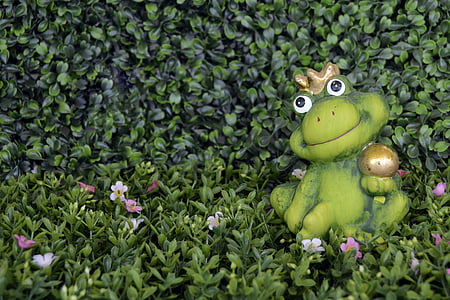 green frog figurine on green leaf plant