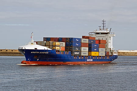 red and red cargo ship on body of water