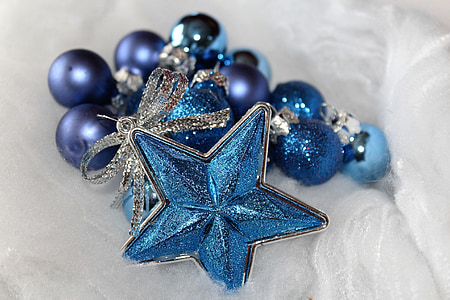 blue star and blue beads on white cushion