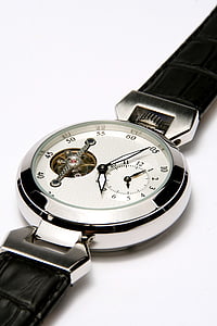 round silver-colored chronograph watch with black leather band on white panel