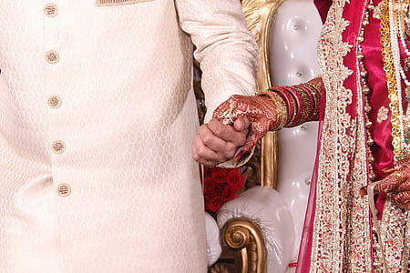 man holding hand of woman