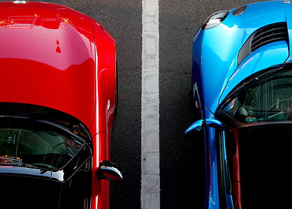 aerial photography of two red and blue cars on highway