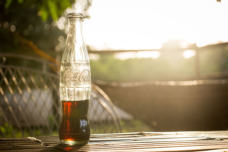 Coca-Cola bottle on brown table