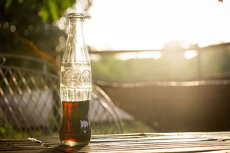Coca-Cola bottle on brown table