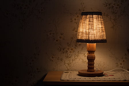 brown table lamp turned on on table