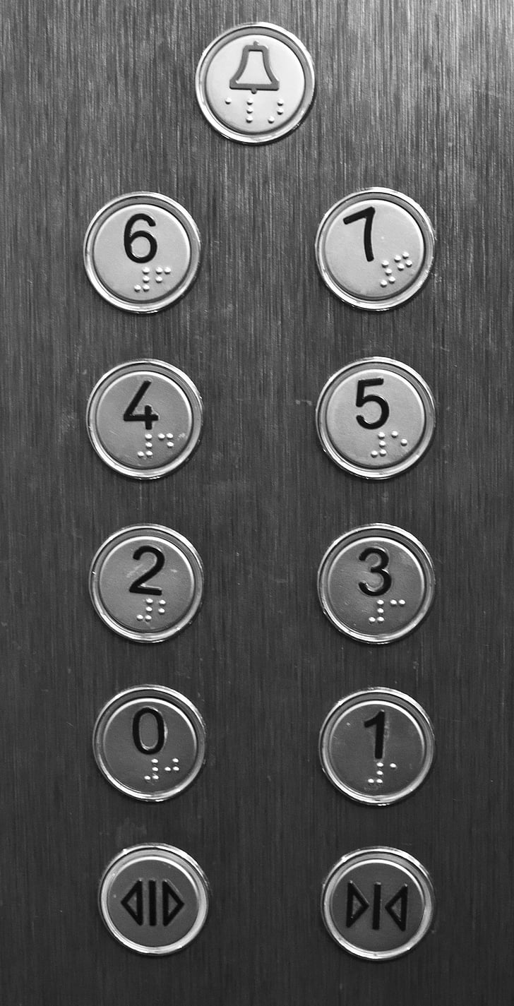 close shot of gray elevator buttons
