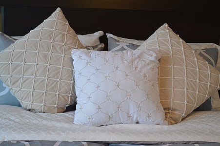 three brown-and-white throw pillows
