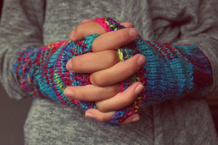 person wearing multicolored gloves