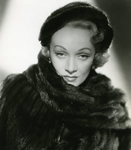 grayscale photo of a woman wearing fur coat