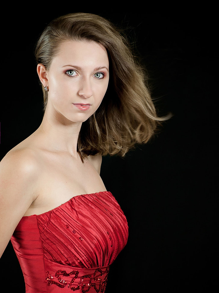 woman wearing red strapless dress