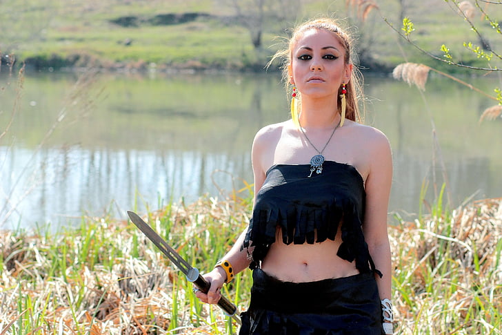 woman in black tube top and black skirt holding sword