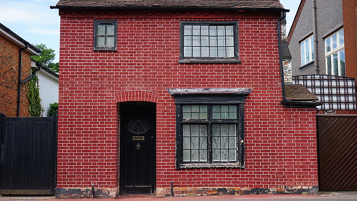 2-storey red brick house during daytime