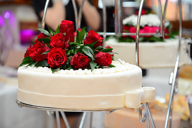 food photography of white fondant-covered cake with red rose flowers