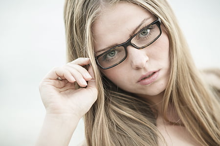 blonde haired woman wearing clear eyeglasses with black frames