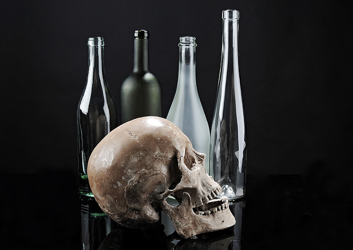 skull beside glass bottles