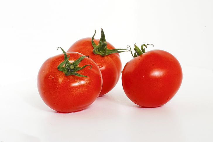 three red cherry tomatoes