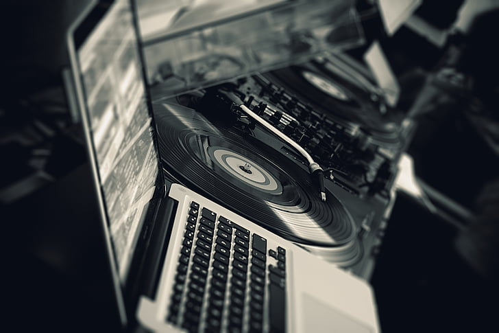 grayscale photography of MacBook and turntable