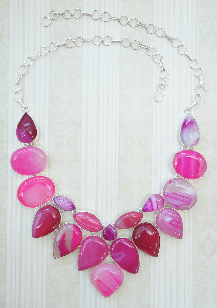 silver-colored necklace with pink stones