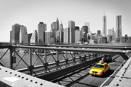 selective color photo of yellow car on bridge