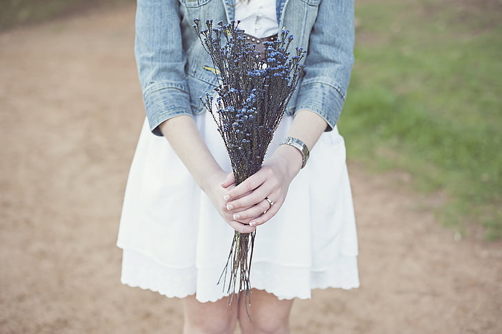 person holding blue flower bouquet