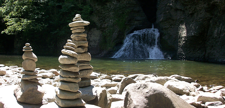 rock formation near water falls during daytime