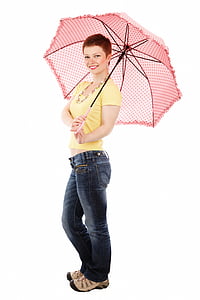 smiling woman wearing yellow blouse and blue denim jeans holding pink umbrella