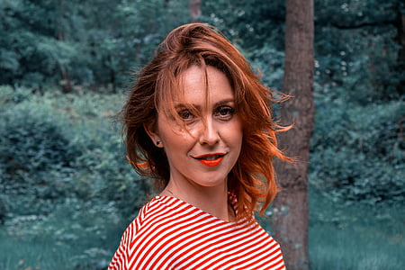smiling woman in white and red striped top