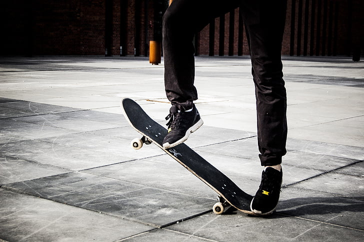 person riding on black skateboard