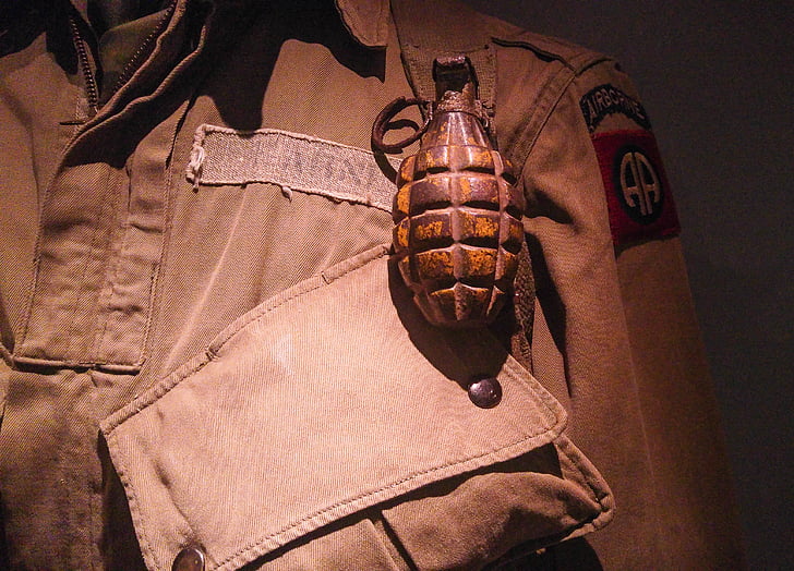 brown grenade on top of uniform