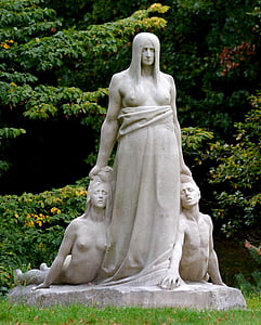 statue of woman holding man and woman at daytime