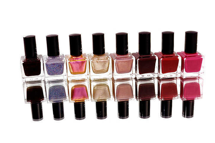 eight assorted-color nail polish bottles reflective photography