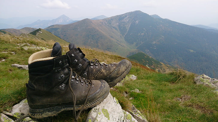 pair of black work boots on mountain
